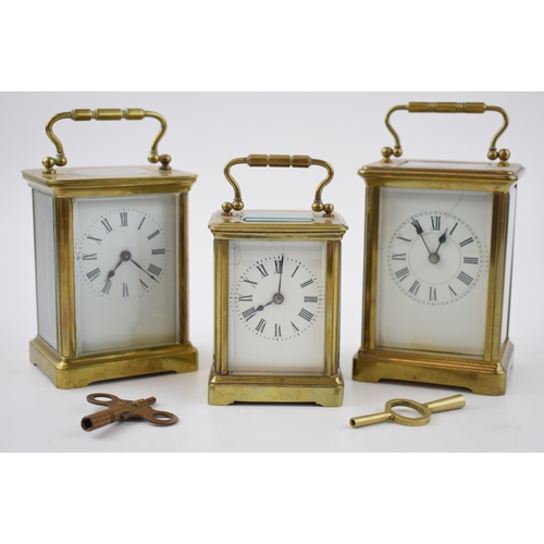 284 - A trio of early 20th century French brass carriage clocks, each with bevelled glass, all unnamed, 2 ... 