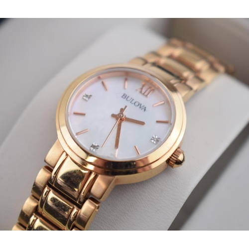 363 - A boxed ladies Bulova quartz wristwatch in rose gold tone case and in original box. Mother of pearl ... 