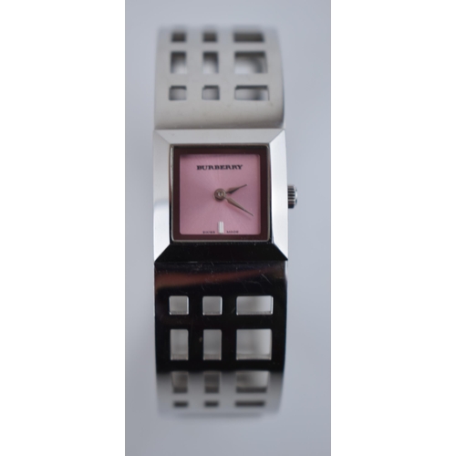 385 - A ladies Burbury's fashion watch with Swiss quartz movement. Pink square dial with applied baton mar... 