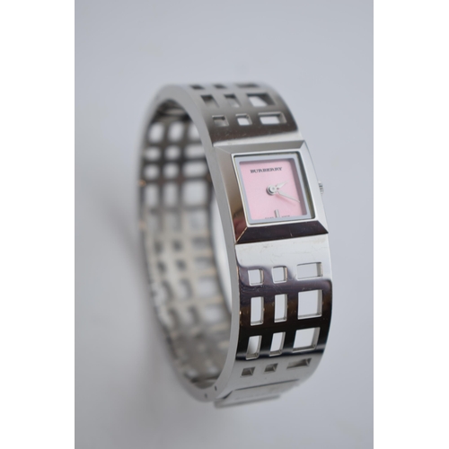 385 - A ladies Burbury's fashion watch with Swiss quartz movement. Pink square dial with applied baton mar... 