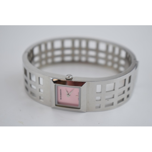 385 - A ladies Burbury's fashion watch with Swiss quartz movement. Pink square dial with applied baton mar... 