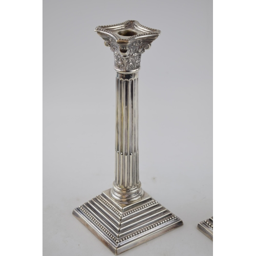 407 - Pair of corinthian column candlesticks  with weighted bases. Sterling silver. Hallmarked Birmingham,... 