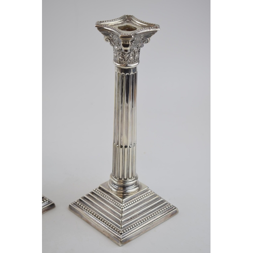 407 - Pair of corinthian column candlesticks  with weighted bases. Sterling silver. Hallmarked Birmingham,... 