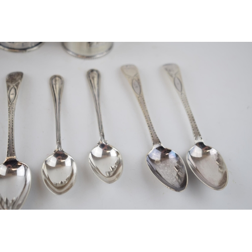 424 - A collection of sterling silver items to include 5 singular napkin rings with tea spoons, combined w... 