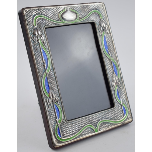 429 - Sterling silver fronted photo frame with enamelled decoration in the Art Nouveau style, 19.5cm tall.