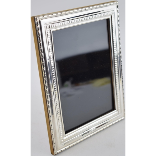 430 - Sterlig silver photo frame with ornate borders, 22.5cm tall, London 2022.