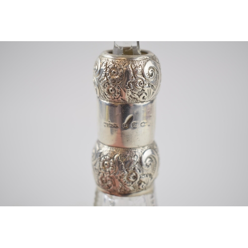 433 - Silver collared cut glass perfume bottle, ornate decoration, Birmingham 1898, J C & Co Ltd, 20cm tal... 