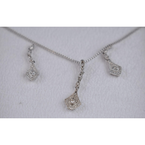 457 - 9ct white gold jewellery set to include a pair of earrings with a pendant and chain, all diamond set... 