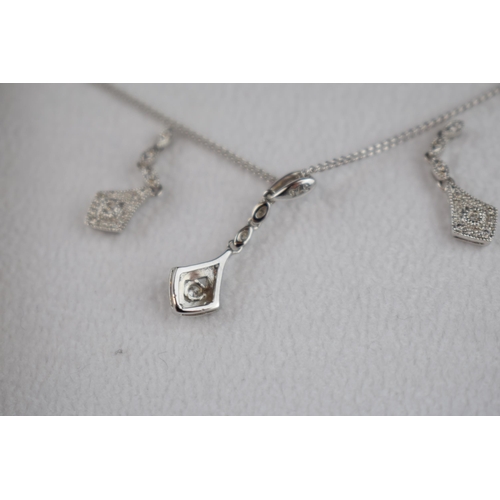 457 - 9ct white gold jewellery set to include a pair of earrings with a pendant and chain, all diamond set... 