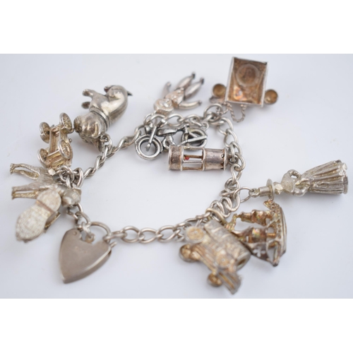 468 - Silver charm bracelet with charms to include an Airedale terrier, a bulldog, a galleon and others, 5... 