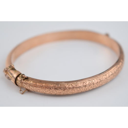 480 - 9ct rose gold hollow bangle with engraved decoration, 8.7 grams.