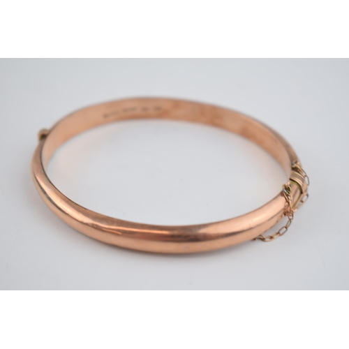 480 - 9ct rose gold hollow bangle with engraved decoration, 8.7 grams.