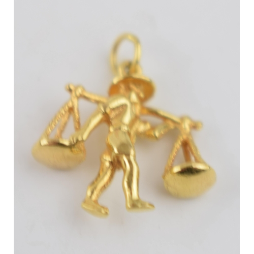 481 - An 18ct gold charm in the form of a man holding balances 3.0 grams, with a collection of 9ct gold je... 