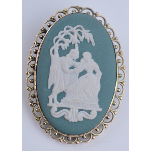 58K - 9ct gold brooch with Wedgwood teal Jasperware insert, 9.9 grams, 4.4cm tall.