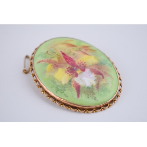 488 - 9ct gold cased painted porcelain miniature, with floral decoration, signed D Dewsberry, 58mm wide, w... 