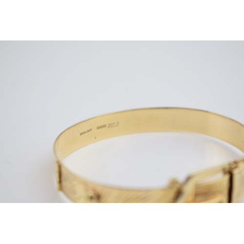 489 - 9ct gold buckle bangle with engraved floral decoration, working buckle, with safety chain, 19.9 gram... 