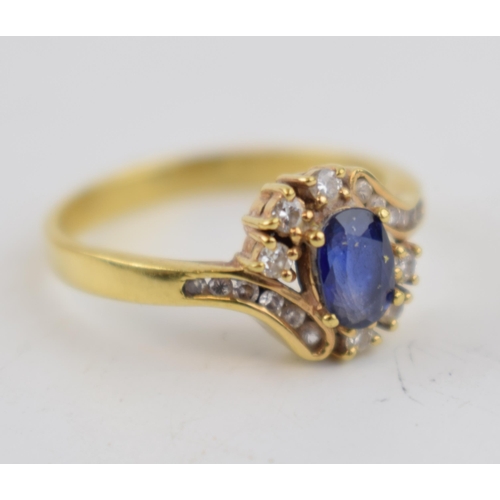 501 - 18ct yellow gold sapphire and diamond oval cluster ring. 3 Diamonds each side with an additional 6 d... 