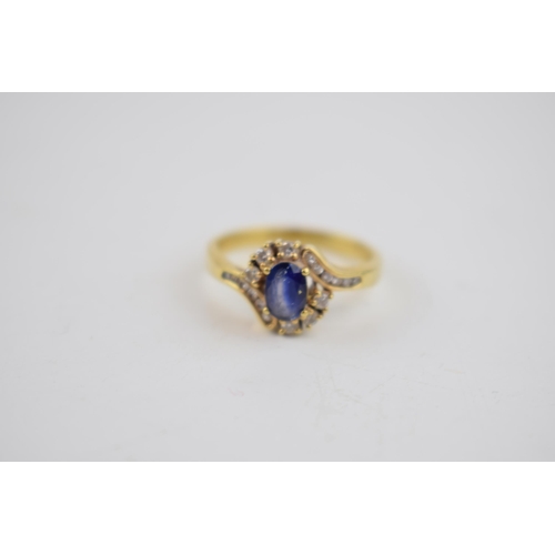 501 - 18ct yellow gold sapphire and diamond oval cluster ring. 3 Diamonds each side with an additional 6 d... 