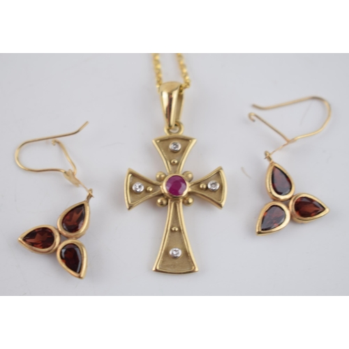 502 - A 9ct yellow gold cross pendant marked .375 set with a ruby and four diamonds, on a 9ct gold chain t... 