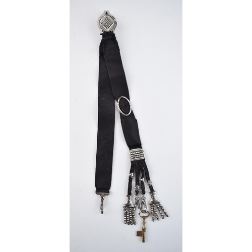 512 - Early Victorian chatelaine with cut steel decoration on black fabric, 25cm long.