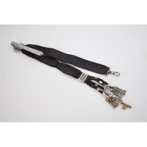 512 - Early Victorian chatelaine with cut steel decoration on black fabric, 25cm long.