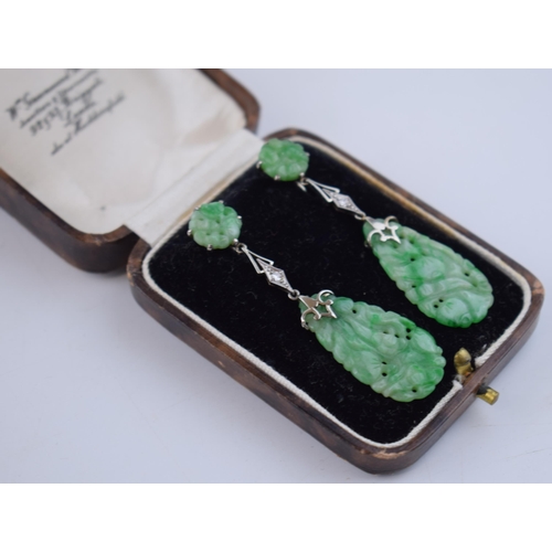 516 - 18ct gold Art Deco earrings with carved jade decoration, each set with a diamond, in period box, 5.5... 
