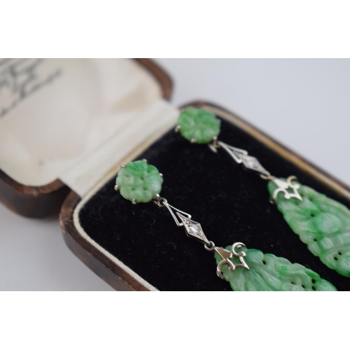 516 - 18ct gold Art Deco earrings with carved jade decoration, each set with a diamond, in period box, 5.5... 
