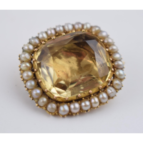 518 - Georgian high carat foil back brooch set with yellow topaz and pearls, 26mm wide, 7.5 grams.