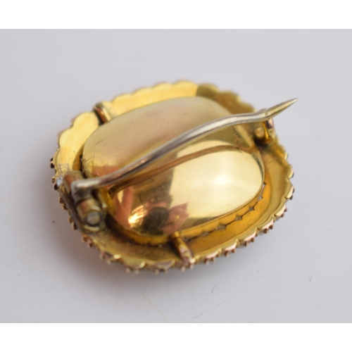 518 - Georgian high carat foil back brooch set with yellow topaz and pearls, 26mm wide, 7.5 grams.