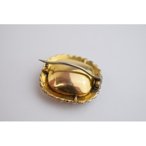 518 - Georgian high carat foil back brooch set with yellow topaz and pearls, 26mm wide, 7.5 grams.