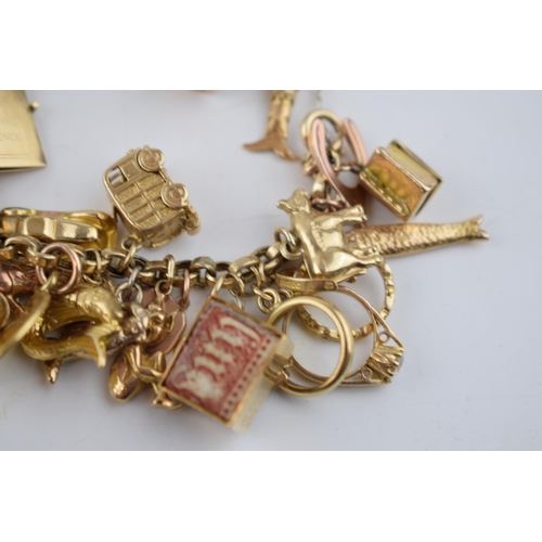 519 - 9ct gold charm bracelet with approximately 44 individual charms. Including a 22ct gold 1/3 Guinea co... 