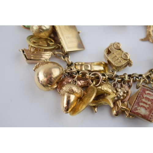 519 - 9ct gold charm bracelet with approximately 44 individual charms. Including a 22ct gold 1/3 Guinea co... 