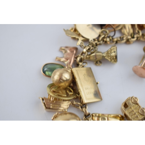 519 - 9ct gold charm bracelet with approximately 44 individual charms. Including a 22ct gold 1/3 Guinea co... 