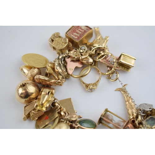 519 - 9ct gold charm bracelet with approximately 44 individual charms. Including a 22ct gold 1/3 Guinea co... 