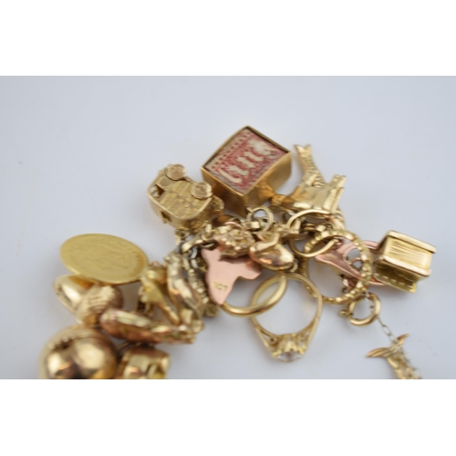 519 - 9ct gold charm bracelet with approximately 44 individual charms. Including a 22ct gold 1/3 Guinea co... 