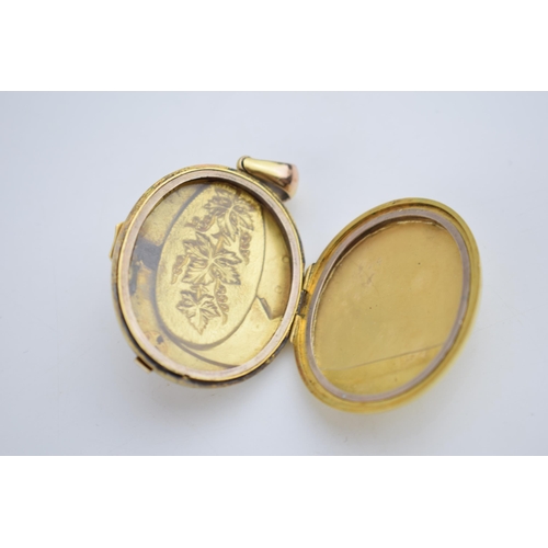 522 - 15ct gold locket with ornate decoration and belt buckle to front, gross 19.2 grams, glass and metal ... 