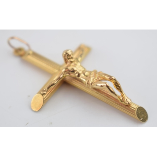 529 - 9ct gold pendant in the form of Jesus upon a crucifix, 52mm tall, 4.7 grams.