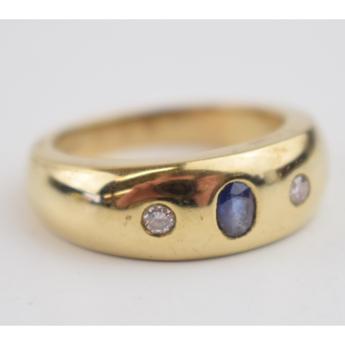 546 - 9ct gold gypsy ring set with a central sapphire, flanked by 2 diamonds, 11.9 grams, size Y.