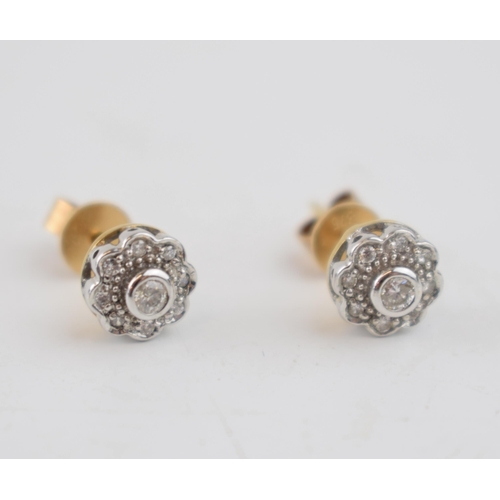 602 - Diamond and 9ct yellow gold daisy head earrings with white gold face and setting, containing a total... 