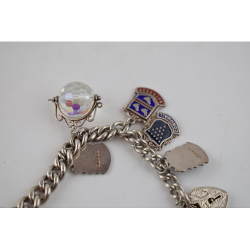 607 - Antique silver bracelet hallmarked on every link. With later silver fobs to include hedgehog, scisso... 