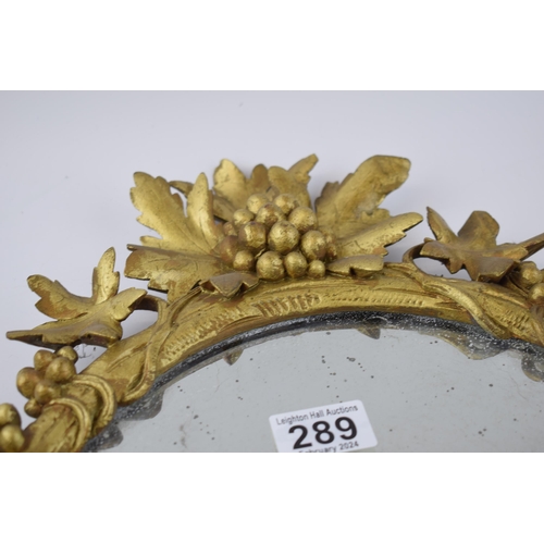 289 - Victorian or earlier carved wooden wall hanging mirror with grape and vine decoration, gilt finish, ... 