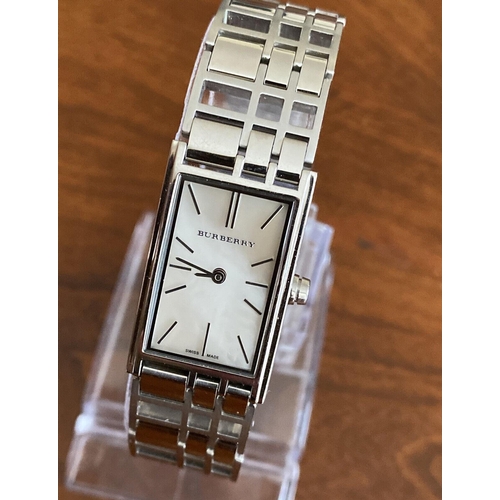 386 - A ladies Burbury's fashion watch with Swiss quartz movement. Mother of pearl effect rectangular dial... 