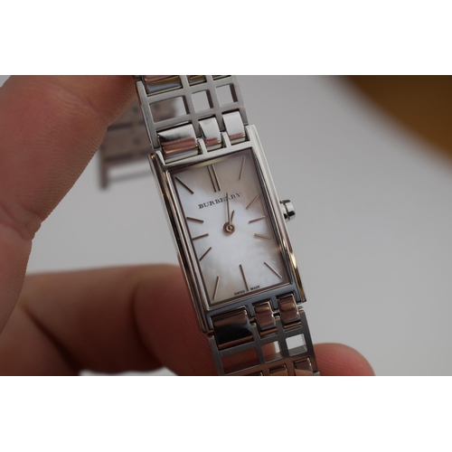 386 - A ladies Burbury's fashion watch with Swiss quartz movement. Mother of pearl effect rectangular dial... 