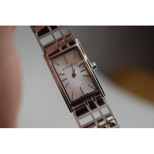 386 - A ladies Burbury's fashion watch with Swiss quartz movement. Mother of pearl effect rectangular dial... 