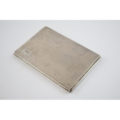 557 - Heavy silver cigarette case with engineered decoration, 201.5 grams, Birmingham 1921.