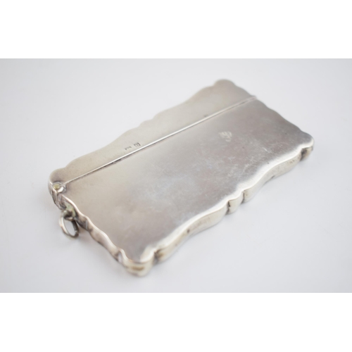 559 - Silver card case with musical engraving, 50.0 grams, Birmingham 1913.