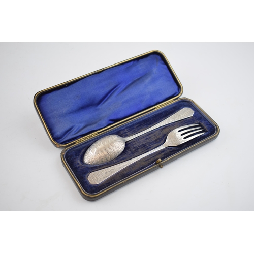 561 - Victorian cased silver spoon and fork, heavily engraved decoration, 61.0 grams, Sheffield 1899.