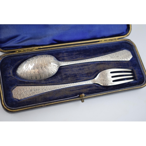 561 - Victorian cased silver spoon and fork, heavily engraved decoration, 61.0 grams, Sheffield 1899.