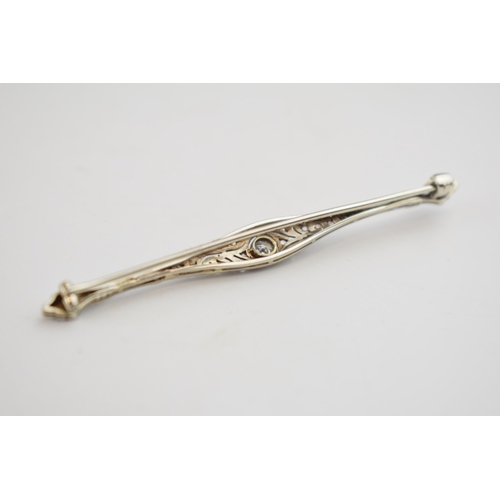 564 - Art Deco white gold (tests as 9ct or better) brooch set with diamonds, 3.2 grams, 6.5cm long.