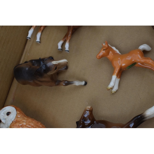 127 - Beswick animals to include an owl, brown foals, a palomino foal, a modern Beswick foal and an unmark... 